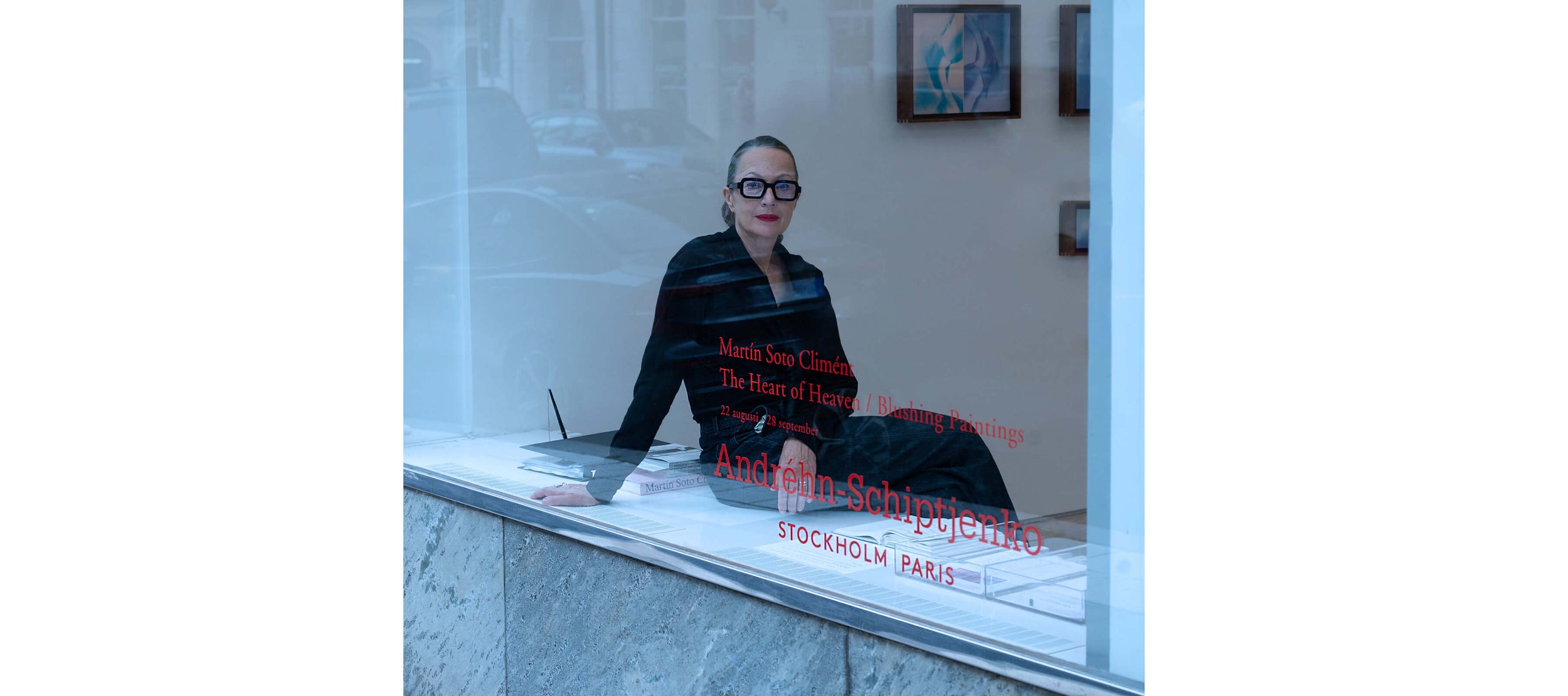 Marina Schiptjenko sitting in the art gallery window wearing Carla OM6 in Deep Ink