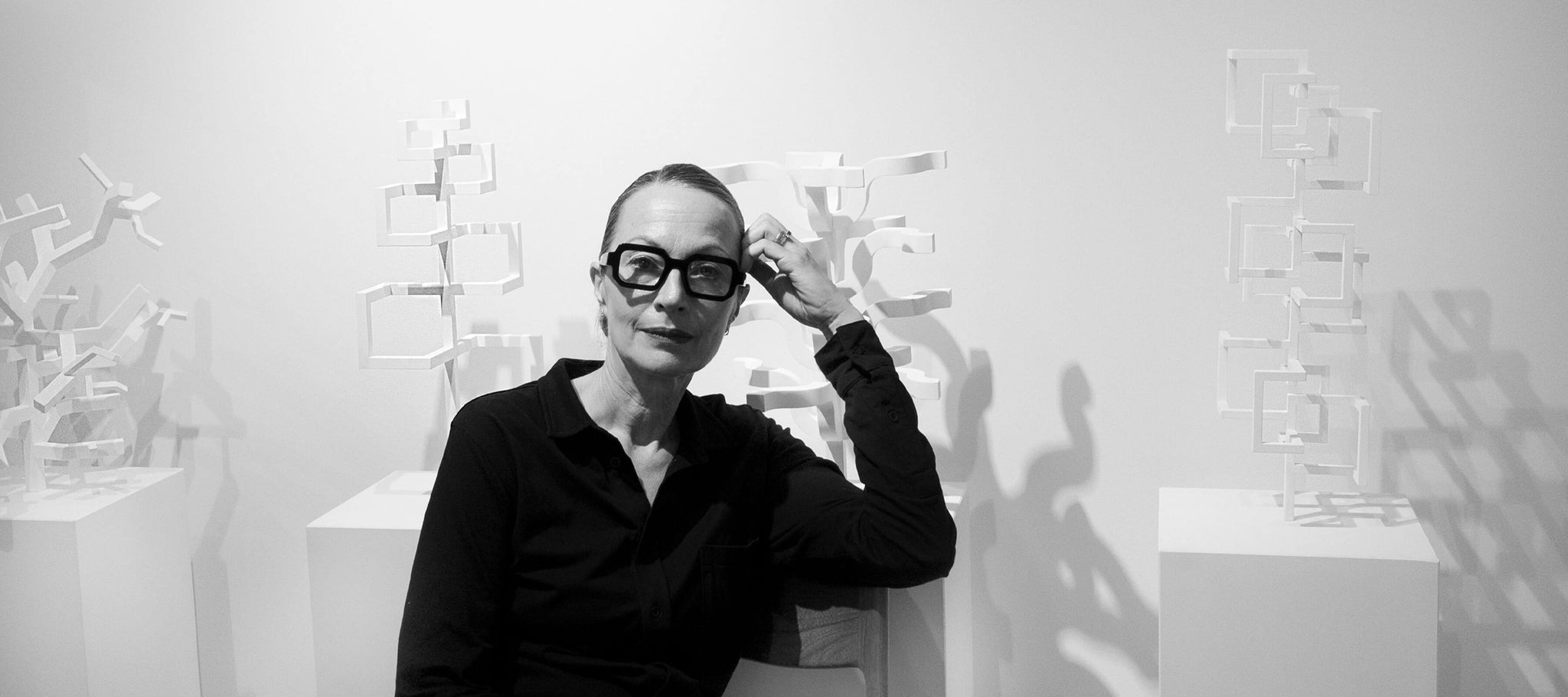 Marina Schiptjenko in front of sculptures by Jacob Dahlgren