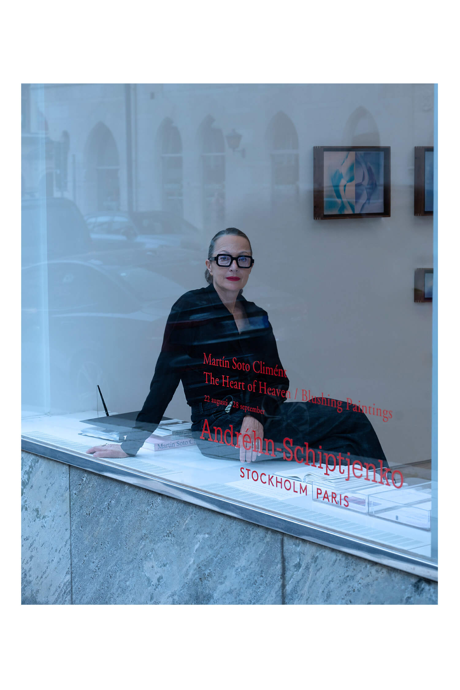 Marina Schiptjenko sitting in the art gallery window wearing Carla OM6 Deep Ink